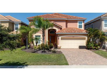 Two story home with tile roof and landscaping at 2588 Shanti Dr, Kissimmee, FL 34746