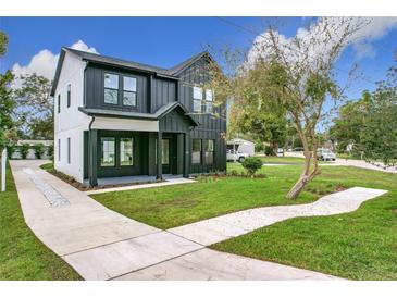 Modern two-story home with black and white exterior, landscaped lawn, and driveway at 3480 Fairway Ln, Orlando, FL 32804