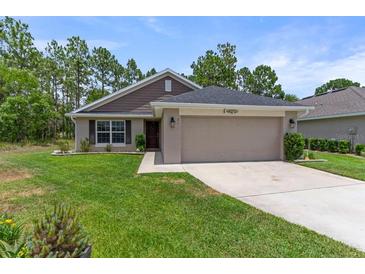 Single-story home with a two-car garage and well-maintained lawn at 31 Diamond Ridge Way, Ocala, FL 34472
