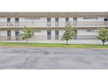 Exterior view of condo building with balconies and landscaping at 700 Melrose Ave # E4, Winter Park, FL 32789