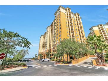 Resort style building with ample parking and lush landscaping at 8125 Resort Village Dr # 5509, Orlando, FL 32821