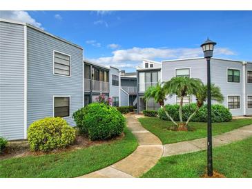 Exterior view of building with landscaping at 3937 Atrium Dr # 5, Orlando, FL 32822