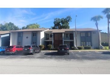 Front view of a two-story building with parking in front at 8 Escondido Cir # 78, Altamonte Springs, FL 32701