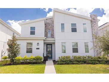 Modern two-story home with clean lines and stylish exterior at 4546 Narrative Ln, Kissimmee, FL 34746