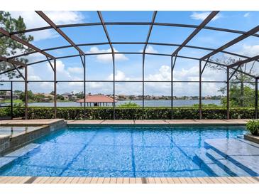 Inviting pool and spa with serene lake views at 11954 Provincial Way, Windermere, FL 34786