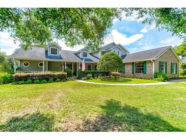 Two-story house with green siding, landscaping, and a walkway at 3202 Misty Morn Ct, St Cloud, FL 34771