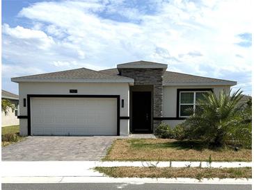 Modern one-story home with a two-car garage at 2927 Camden Way, Davenport, FL 33837