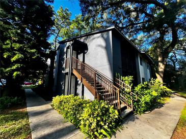 Exterior view of a building with stairs and landscaping at 180 Waterfall Way # 203, Altamonte Springs, FL 32714