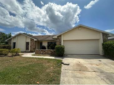 Single-story home with attached garage and landscaped yard at 368 Fairgreen Pl, Casselberry, FL 32707