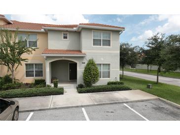 Two-story townhome with front yard and parking at 8951 Bismarck Palm Rd, Kissimmee, FL 34747