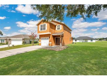 Two-story house with attached garage and landscaped yard at 2911 Se 75Th Blvd, Bushnell, FL 33513