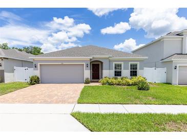 Front view of house with a well manicured lawn at 122 Blue Cypress Drive, Davenport, FL 33837