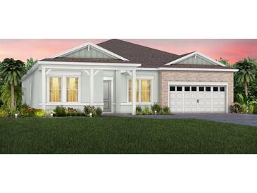 One-story home with light-green exterior and white garage at 15404 Blue Spruce Dr, Montverde, FL 34756