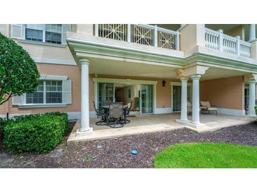 Covered patio with seating area and access to interior at 1350 Centre Court Ridge # 103, Reunion, FL 34747