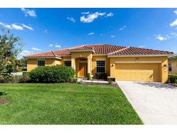 House exterior featuring a two-car garage and well-maintained lawn at 4036 Oakrise Loop, Davenport, FL 33837