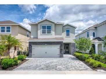 Two-story house with stone accents and a paved driveway at 171 Burma St, Kissimmee, FL 34747