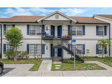 Two-story building with blue accents and balconies at 3651 N Goldenrod Rd # B107, Winter Park, FL 32792
