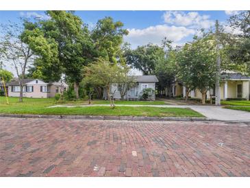 Quaint bungalow home on a tree-lined street with brick sidewalks at 31 W Harding St, Orlando, FL 32806