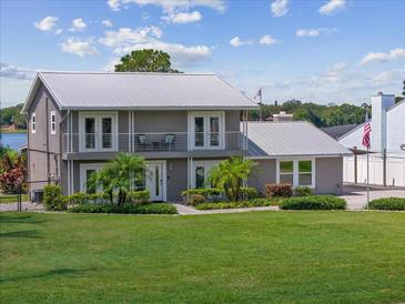 Two-story home with metal roof and large yard at 7220 Grace Rd, Orlando, FL 32819