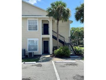 Tan building exterior with black metal staircase and parking at 1059 S Hiawassee Rd # 1824, Orlando, FL 32835