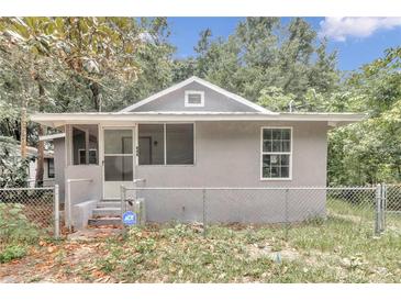 Front view of a renovated gray house with fenced yard at 448 Nw 18Th Ave, Ocala, FL 34475