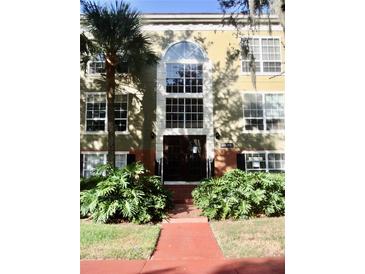 Building front with manicured landscaping at 4146 Versailles Dr # 4146D, Orlando, FL 32808