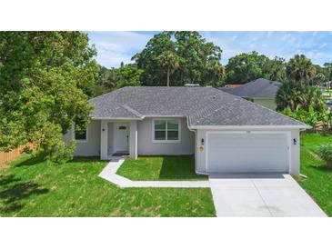 Single-story home with attached garage and landscaped lawn at 370 Routh Ave, New Smyrna Beach, FL 32168