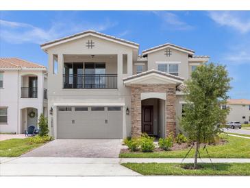 Two-story house with a gray exterior, two-car garage, and landscaping at 13839 Larkton Ln, Orlando, FL 32832