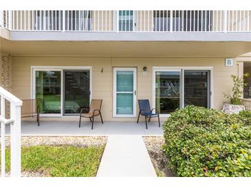 Ground floor condo with patio furniture and slider doors at 335 N Causeway # B010, New Smyrna Beach, FL 32169