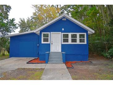 Blue house exterior with a gray walkway and landscaping at 647 S Delaware Ave, Deland, FL 32720