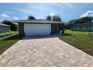 Newly constructed home with a paved driveway and a single car garage at 2220 Church St, Sanford, FL 32771