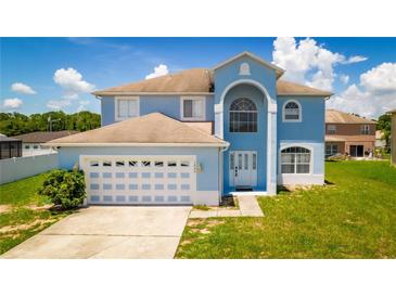 Stunning two-story home with a spacious lawn at 1233 Nelson Park Court, Poinciana, FL 34759