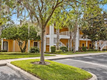 Two-story building with inviting landscaping and parking at 401 New Providence Promenade # 12401, Davenport, FL 33897