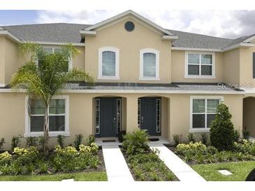 Two-story townhome with front yard landscaping at 1505 Carey Palm Cir, Kissimmee, FL 34747