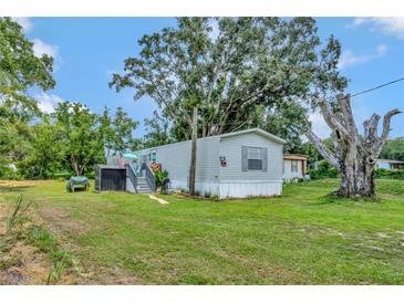 Single wide mobile home with large tree in the backyard at 1825 Ruby St, Lakeland, FL 33815