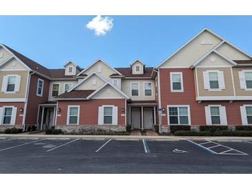 Townhouse exterior with parking and appealing curb appeal at 7571 Sunny Dreams Ln, Kissimmee, FL 34747