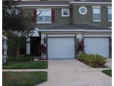 Two-story townhome with two-car garage and landscaping at 3514 Victoria Pines Dr # 148, Orlando, FL 32829