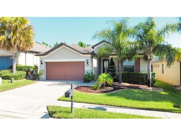 One-story house with attached garage and landscaped front yard at 333 Navarra Ln, Davenport, FL 33837