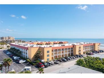 Aerial view of beachfront condo building with parking and ocean views at 3801 S Atlantic Ave # 321, New Smyrna Beach, FL 32169