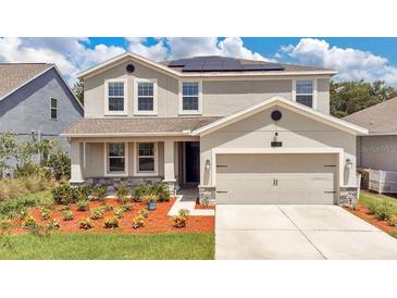 Two-story house with a two-car garage and landscaping at 2361 Crescent Moon St, Kissimmee, FL 34746