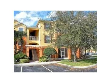 Two-story condo building with balconies and landscaping at 8710 Saratoga Inlet Dr # 305, Orlando, FL 32829