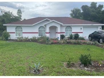 Single story home with red roof and well maintained lawn at 2135 Sw 156Th Pl, Ocala, FL 34473