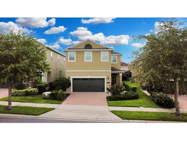 Two-story house with a two-car garage and landscaped yard at 601 Lasso Dr, Kissimmee, FL 34747