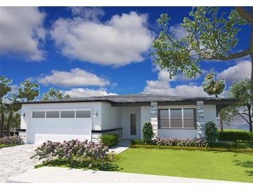 Modern house exterior with attached garage and landscaping at 2659 Trafalgar Blvd, Kissimmee, FL 34758