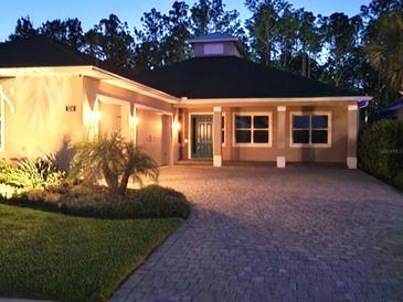 Attractive single-story home with landscaping and a paved driveway at 124 Cerise Ct, Daytona Beach, FL 32124