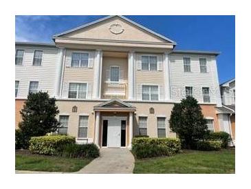 Three-story building with columns and landscaping at 1597 Heritage Crossing Ct # 202, Reunion, FL 34747