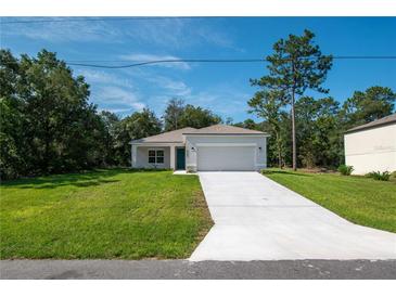 Newly built one story home with a large yard and driveway at 34 Dogwood Dr Crse, Ocala, FL 34472