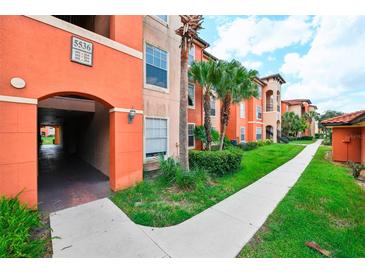 Attractive building exterior with landscaping and walkway at 5536 Metrowest Blvd # 8-304, Orlando, FL 32811