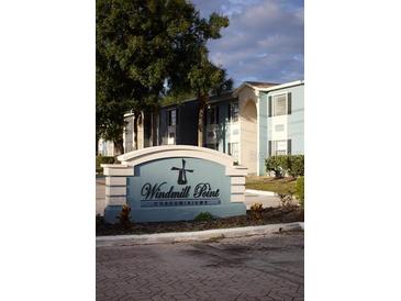 Windmill Point Condominiums building exterior with landscaping and signage at 2557 N Alafaya Trl # 111, Orlando, FL 32826