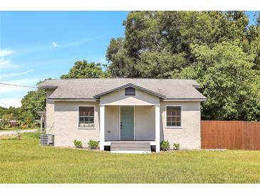 Charming single-story home with a teal door and wood fence at 1500 N Clearview Ave, Deland, FL 32724
